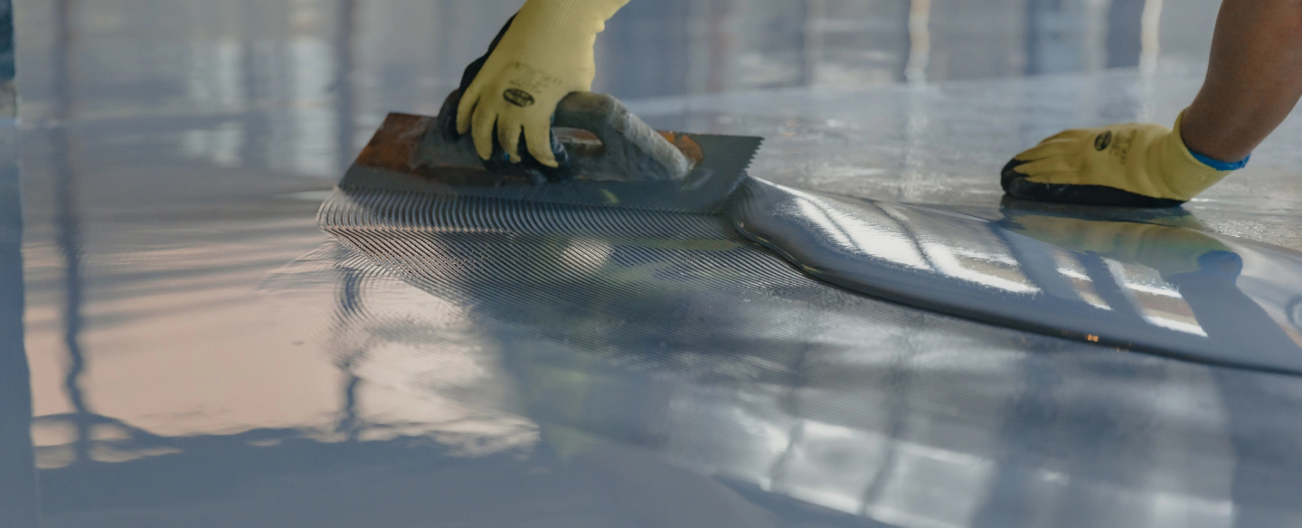 worker applying gray epoxy resin